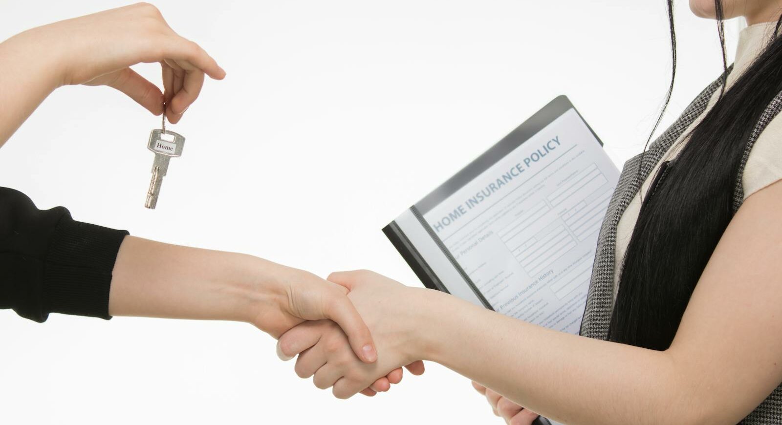 A real estate transaction with a handshake and key exchange, highlighting a home insurance document.